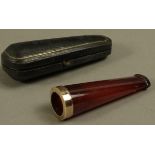 An Edward VII cigar holder in amber with rolled gold ferrule cased