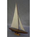 A pond yacht, mid 20th century, varnished and painted wood construction with two sails,