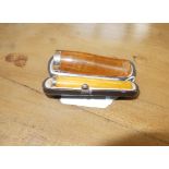 A Victorian composite and 9ct cigar holder together with an amber and silver cigarette holder cased