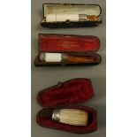 A Victorian meerschaum, amber and silver cigar holder, together with an Edward VII meerschaum,