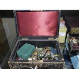 A Victorian black embossed leather jewellery case with tiered interior containing a collection of