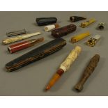 A collection of cigar, cigarette holders and cigar cutters including meerschaum, amber, bone,