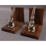 A pair of hardwood and horn 'rabbit' bookends