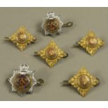 Four officer's pips for the brigade of Guards in brass with red and green enamel,