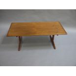 A modern teak coffee table , rectangular, on refectory supports,