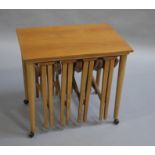 A nest of five teak occasional tables