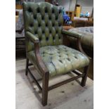 A green leather buttoned open armed chair on square legs Please Note: This furniture was either
