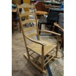 A beech ladderback and rush seated rocking chair, c.