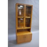 A G Plan teak two glazed door wall unit with two door cupboard to base,