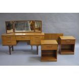 A teak dressing table, a pair of bedside cabinets and a double headboard,