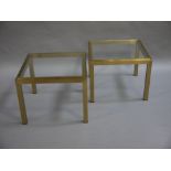 A pair of gilt metal and glass inset lamp tables on square legs,