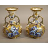 A pair of Carlton ware bottle shaped two handled vases the bodies decorated in under glaze blue