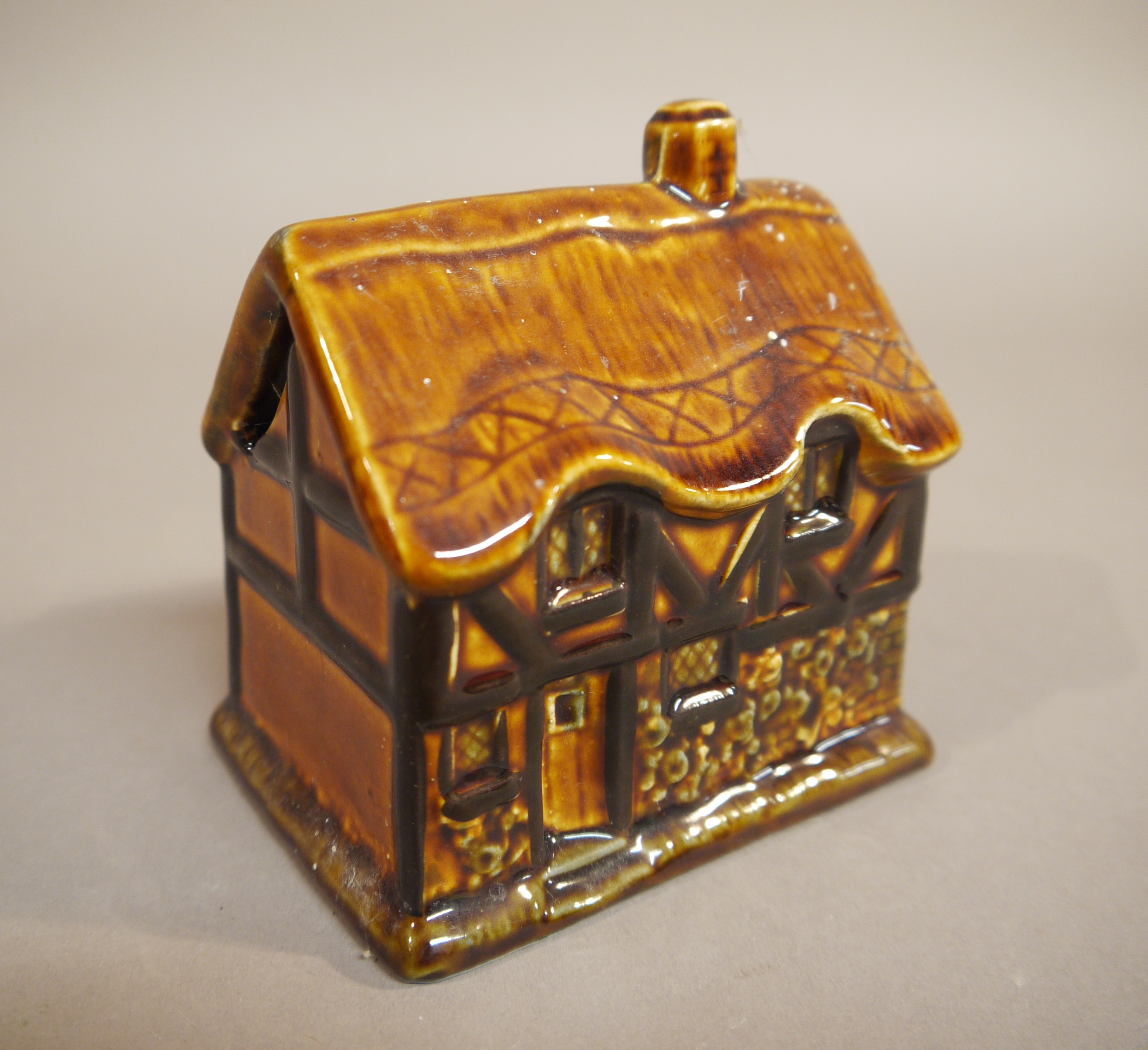 A brown treacle glazed cottage ornate; three others, a moulded pottery money bank, - Image 4 of 5