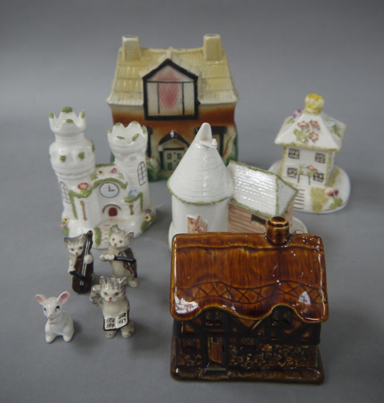 A brown treacle glazed cottage ornate; three others, a moulded pottery money bank,