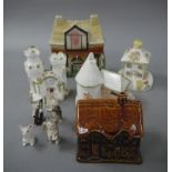 A brown treacle glazed cottage ornate; three others, a moulded pottery money bank,