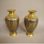 A pair of Middle Eastern brass vases worked in white colour metal and copper with Islamic script
