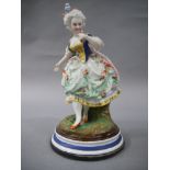 A continental bisque porcelain figure of a young women with blue and yellow bodice and floral