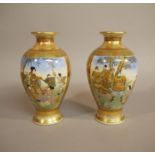 A good pair of Japanese satsuma pottery baluster vases each painted with two panels,