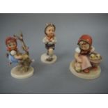 Three Hummel figures, young girl with chicks, boy with satchel on his back,