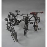 Three reproduction miniature cycles including tricycle and penny farthing,