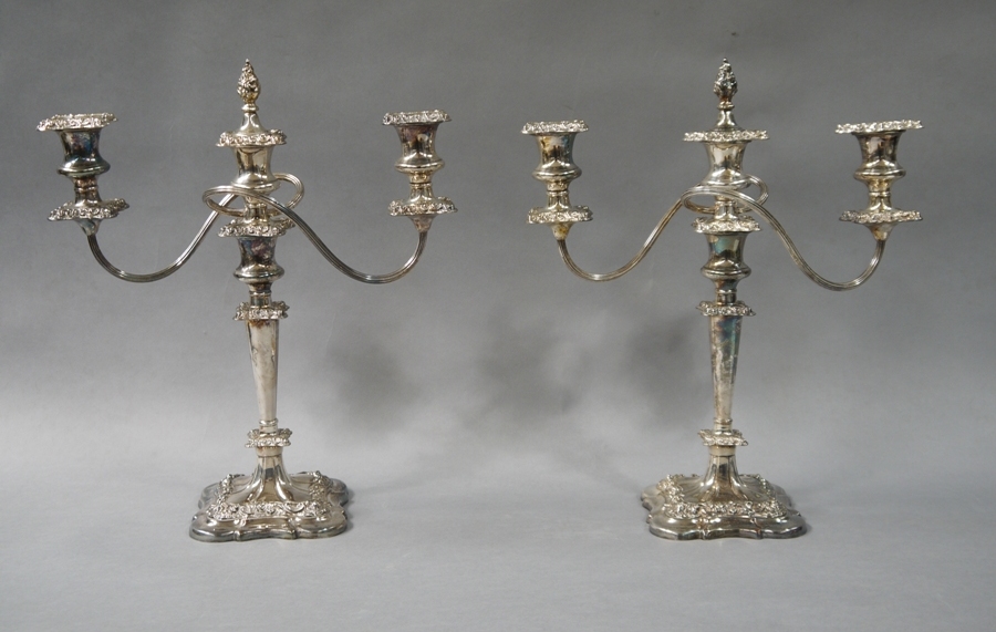 A pair of silver plated two branch candelabrum in George III style,