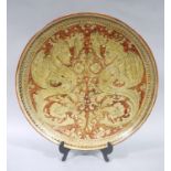 A large Italian pottery circular charger painted with a pair of mythical beast and stylised sea