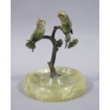 A cold painted bronze and onyx ashtray, the rising branch cast with a pair of budgerigars, 13.