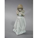 A Lladro Collectors Society, 1987, figure of a young woman carrying two floral bouquets,