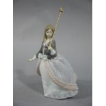 A Lladro figure of a young woman with a parasol,