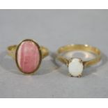 A dress ring in 9ct gold collet set with an oval Rhoda cabochon stone together with an opal dress