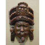 A carved mask face,