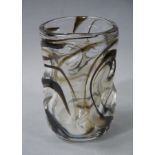 An art glass vase of moulded cylindrical form with internal brown swirls,