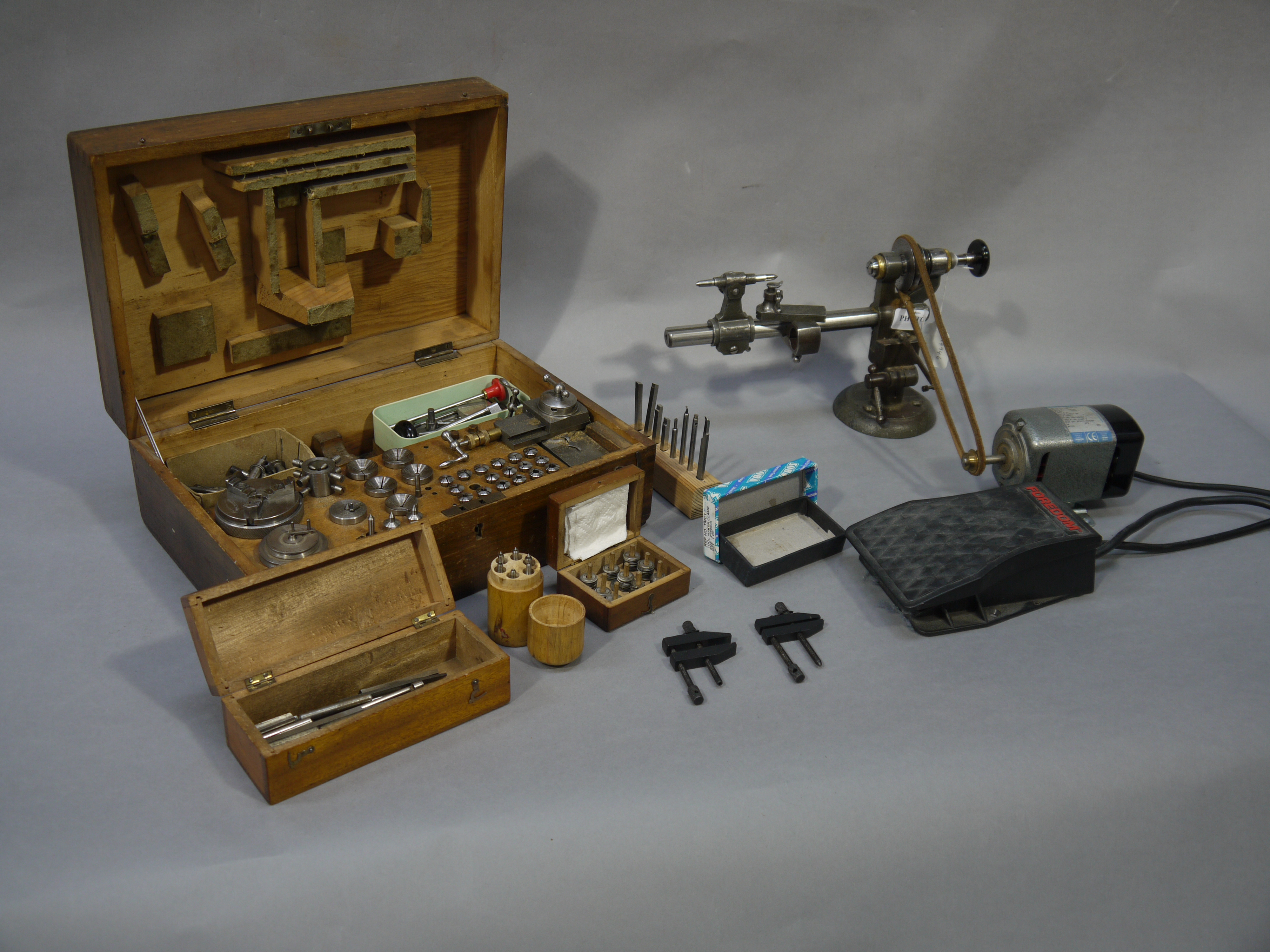 A mid 20th century watch makers lathe complete with bed and chucks, cutting tools,