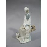 A Lladro figure of a young girl seated on rustic bench with basket at her feet,