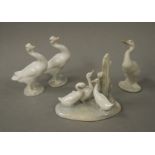 Three Lladro figures of ducks, one bisque, 12cm high; a Nao figure group of three ducks,