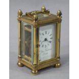 A reproduction brass cased miniature carriage timepiece,