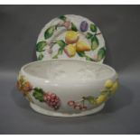An Italian fruit moulded oval planter, 35cm wide; a fruit moulded circular plate,