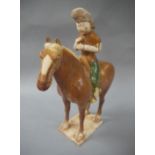 A Chinese Tang style pottery horse and rider,