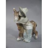 A Lladro figure of a young boy and donkey,