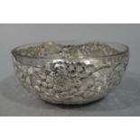 A Japanese silver pierced circular bowl decorated with chrysanthemum blooms and leafage,