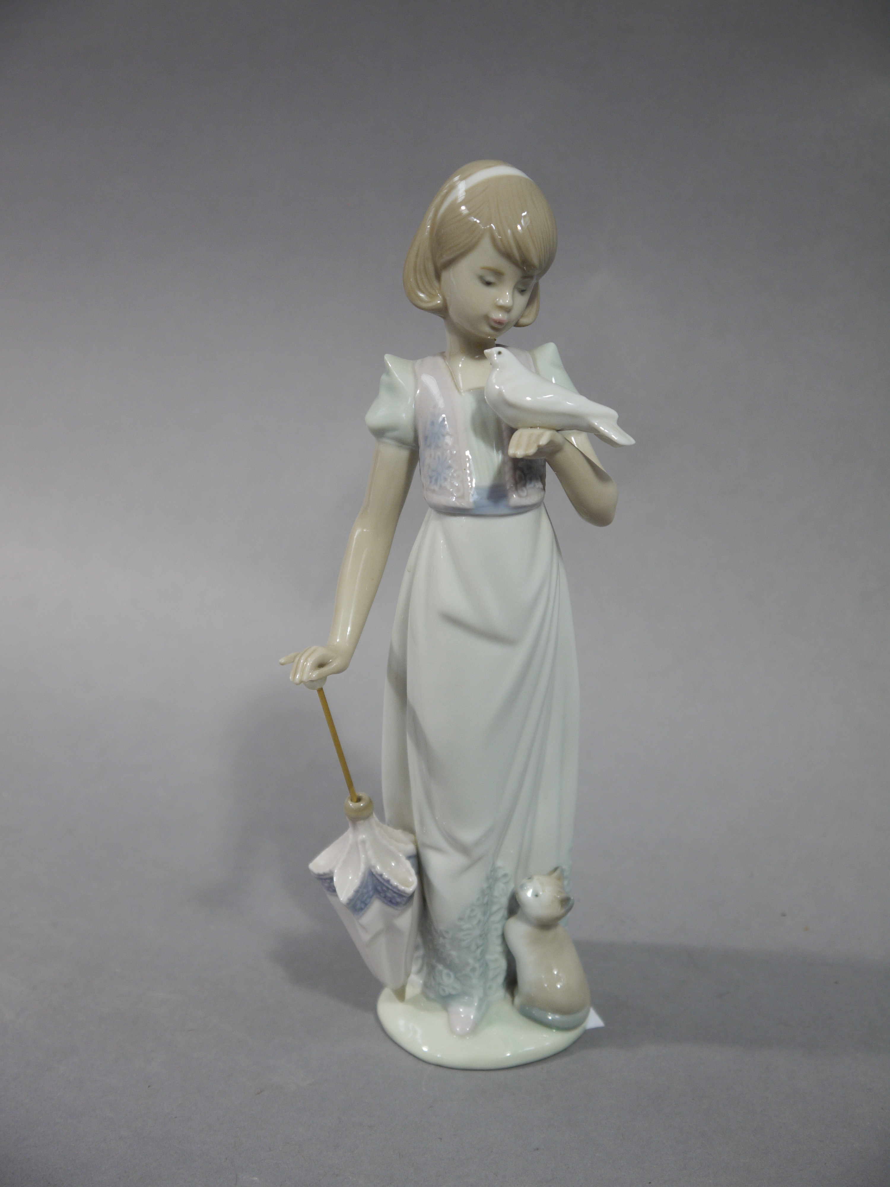 A Lladro Collectors Society, 1991, figure of a young woman with umbrella in her right hand,