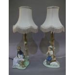 A pair of porcelain Nao table lamps, one modelled as a female seated with rabbits,
