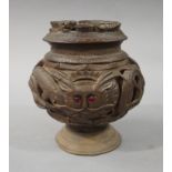 A Chinese hardwood pedestal jar and cover the shallow lid carved with a dragon the body relief