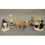 A porcelain model of a seated pig,