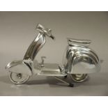 A reproduction white metal model of a scooter,