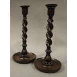 A pair of oak barley twist table candlesticks with copper drip pans, 30cm high,