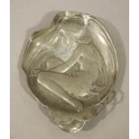 An Art Nouveau pewter dish cast with a naked female form and water lilies