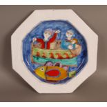 An Italian glazed terracotta octagonal plate decorated to the centre with figures in a boat and