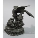 A reproduction bronze figure of an eagle attacking a snake in Japanese Meiji style,