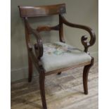 An early 19th century mahogany carver chair having a broad top rail, conforming tie rail,